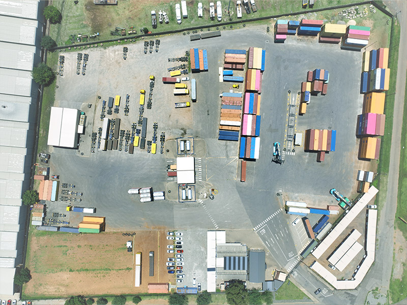 Full Container Depot with stacked containers and transport vehicles for efficient logistics.
